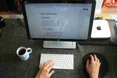 Student blogging on a desktop, sharing insights and experiences on their personal blog